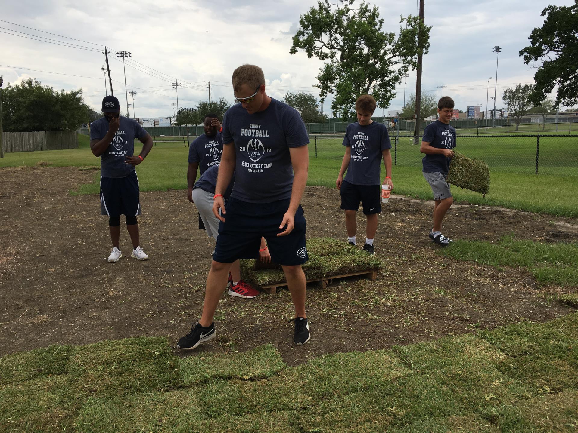 Volunteers from Emery/Weiner High School lay sod at Independence Park dog park. 