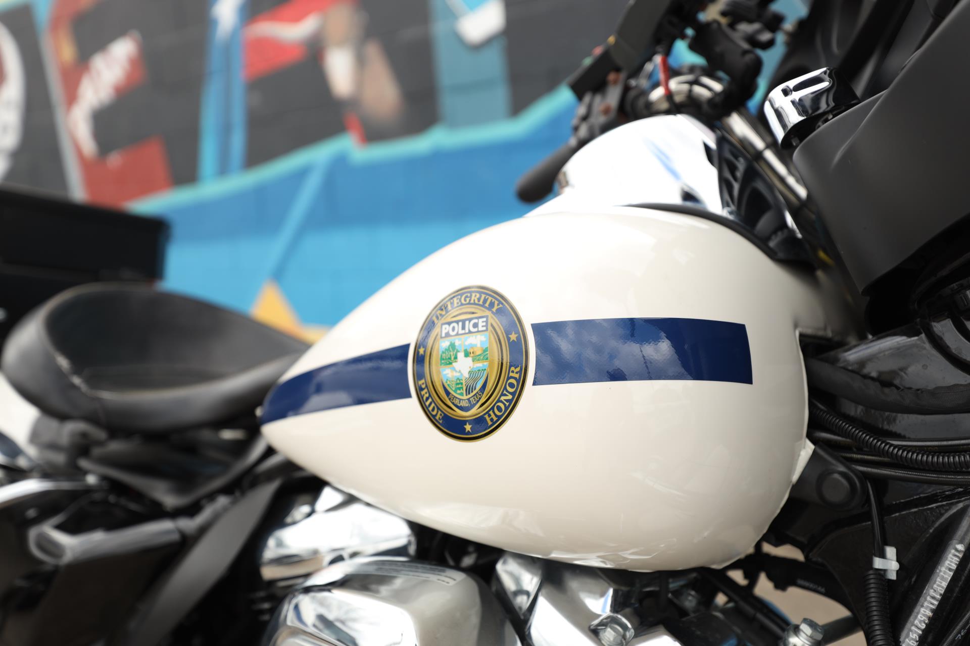 pearland pd motorcycle in front of mural