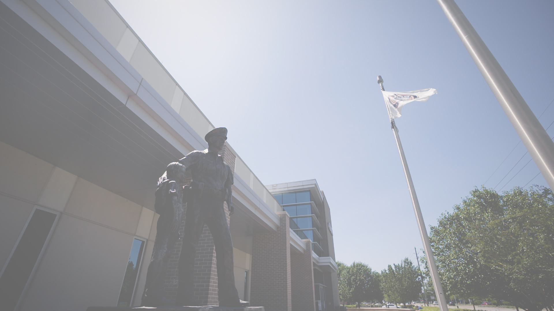 front of pearland safety building, looking up at statue of officer and child